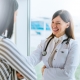 Cheerful doctor talking with her patient near window